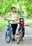 Mom and daughter ride bikes in the park