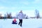 Mom and daughter ride a tubing in winter.