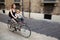 Mom with daughter riding bike in Italy. Child sitting in safety