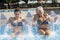 mom and daughter while spraying water in a whirlpool tub inside a swimming pool