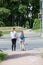 Mom and daughter stand on pedestrian crossing on red light, waiting green light