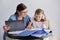 Mom and daughter student learning school lessons together at home