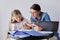 Mom and daughter student learning school lessons together at home