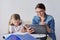 Mom and daughter student learning school lessons together at home