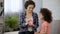 Mom and daughter throwing coins into piggy bank, saving money for presents