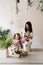 mom and daughter together make a bouquet of flowers at the table