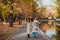 Mom and daughter and walk in the autumn Park near the lake