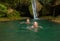 Mom and daughter at a waterfall in the jungle. Travel in nature near a beautiful waterfall, Turkey.