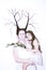 Mom and daughter in white dresses on a white background depict winter and spring, holding flowers and a twig with leaves. Hair bra