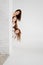 Mom and daughters pose in a white photo studio. hair care products.