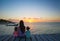 Mom and daughters silhouette in the sunset on the