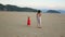 Mom and daughters walk along the beach at dawn