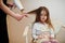 Mom with dauhter making everyday routine together. Mother is brushing and drying child hair after shower