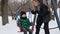 Mom entertains the baby on a winter swing