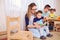 Mom and father read a book with the children in room