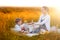 Mom feeds her son on a picnic. Mother and young son in sunny fall day. Happy family and healthy eating concept