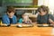 Mom and grandmother feed the little girl together.