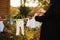 Mom hanging baby clothes on a clothesline outdoor in sunny autumn day.