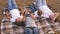 Mom and happy children are photographed on smartphone in park. Mother and daughters take a selfie while traveling, lying