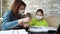 Mom helping daughter with homework during pandemic