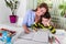 Mom helping little boy to do homework. Mother and son drawing together, mom helping with homework. Cute boy doing his school