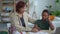 Mom helping son with study and sitting at table with laptop in home room spbd.