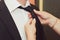 Mom helps her son get ready for the wedding