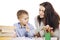 Mom helps her son to do homework, isolated on a white background. Tenderness, love