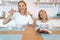 Mom with her daughter eating chocolate flakes. hold spoons by mouth and smile. have a good time together, dressed alike