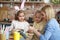 Mom with her daughters preparing Easter decorations at home