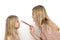 Mom with her little daughter dressed in charging pink dresses cheerfully and playfully powder their noses with a makeup brush