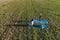 Mom with her little daughter stretching on the mat on the field in warm summer day. Aerial panoramic view.