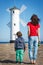 Mom and her son on west breakwater in Swinoujscie by characteristic navigational mark Windmill Stawa MÅ‚yny. Vacation time