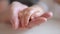 mom holds the hand of a newborn. close-up baby hand. hospital caring happy family medicine concept. baby newborn holding