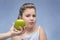 Mom holds out a green Apple to a fat kid. refusal of proper nutrition . parental control of nutrition. problem of obesity. blue