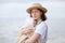 Mom holds sleeping baby in her arms. mother and child infant together outdoor see beach