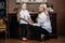 Mom hugs her little daughter in his office, pausing in the work to pay attention to the child