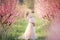 Mom with an infant in the rose garden with flowers trees