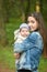 Mom in jeans with a baby. mother and her little daughter park