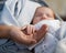 Mom keeps miniature hand newborn baby in hands