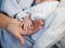 Mom keeps miniature hand newborn baby in hands