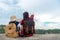 Mom and kid holding maps and travel backpacks sitting victorious facing on the grand canyon for education nature