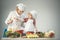 Mom and kid with smiling face cooking spaghetti together.