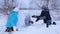 Mom and kids throw snow on each other and enjoy it in the winter Park. Winter walks in the Park. The laughter and joy of