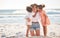 Mom, kiss or children bonding on beach in Portugal in trust, security or love hug. Smile, happy or support parent with
