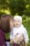 Mom kisses happy baby