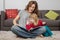 Mom and little child reading a tale book at home