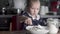 Mom and little daughter cook at home.