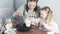 Mom and little daughter cook omelet at home