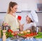 Mom and little daughter cooking vegeterian dish indoors